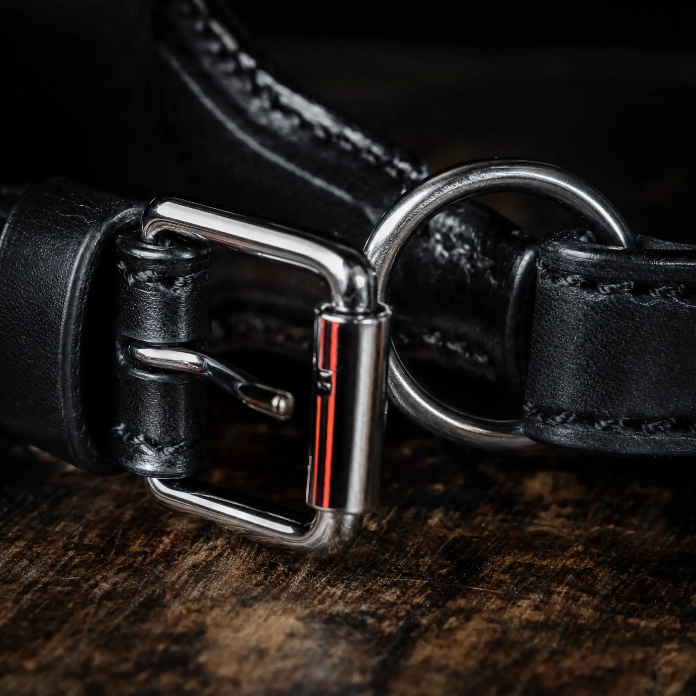 Chrome buckle and steel ring hardware on black bridle leather
